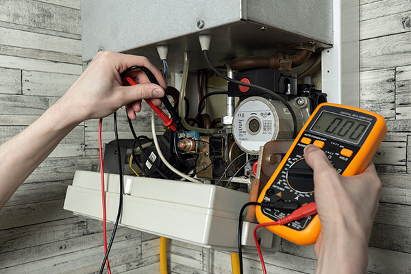 hands using multimeter to troubleshoot electrical connections in a heating system for effective performance and maintenance with 11 voltage readings